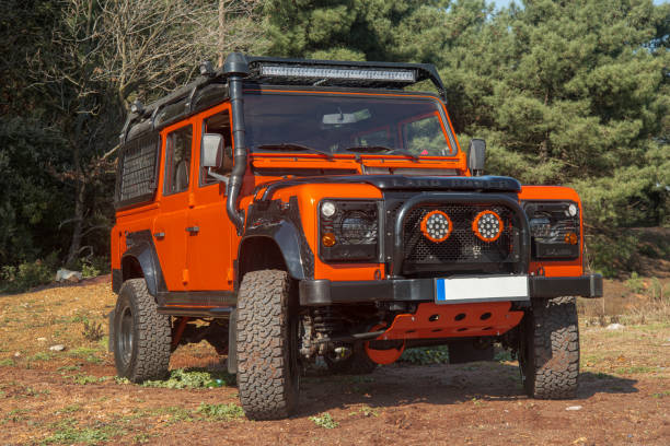 Istanbul Turkey - March 12, 2018: Orange Land Rover jeep,model Defender on the forest