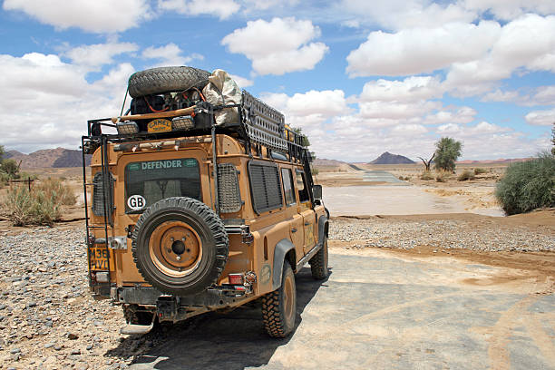 "Namib Desert, Namibia - February 10, 2008: Land Rover can't pass the flooded Tsauchab River. The Road to Sossuvlei is closed. It's very seldom - and only at the rainy season. Namib Desert. Namibia"